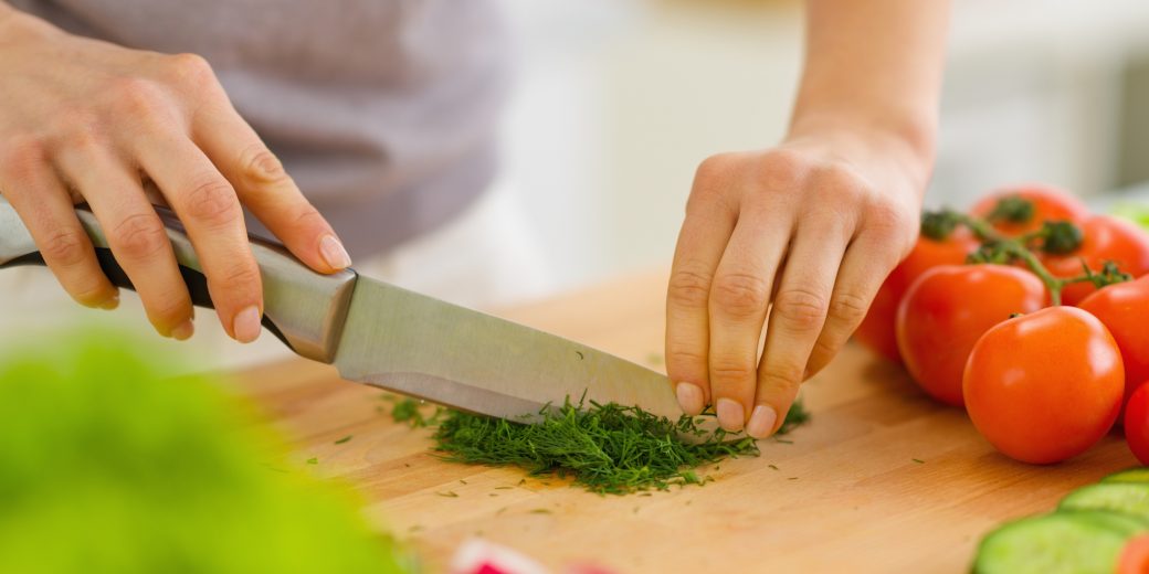 Closeup on woman cutting fresh dill